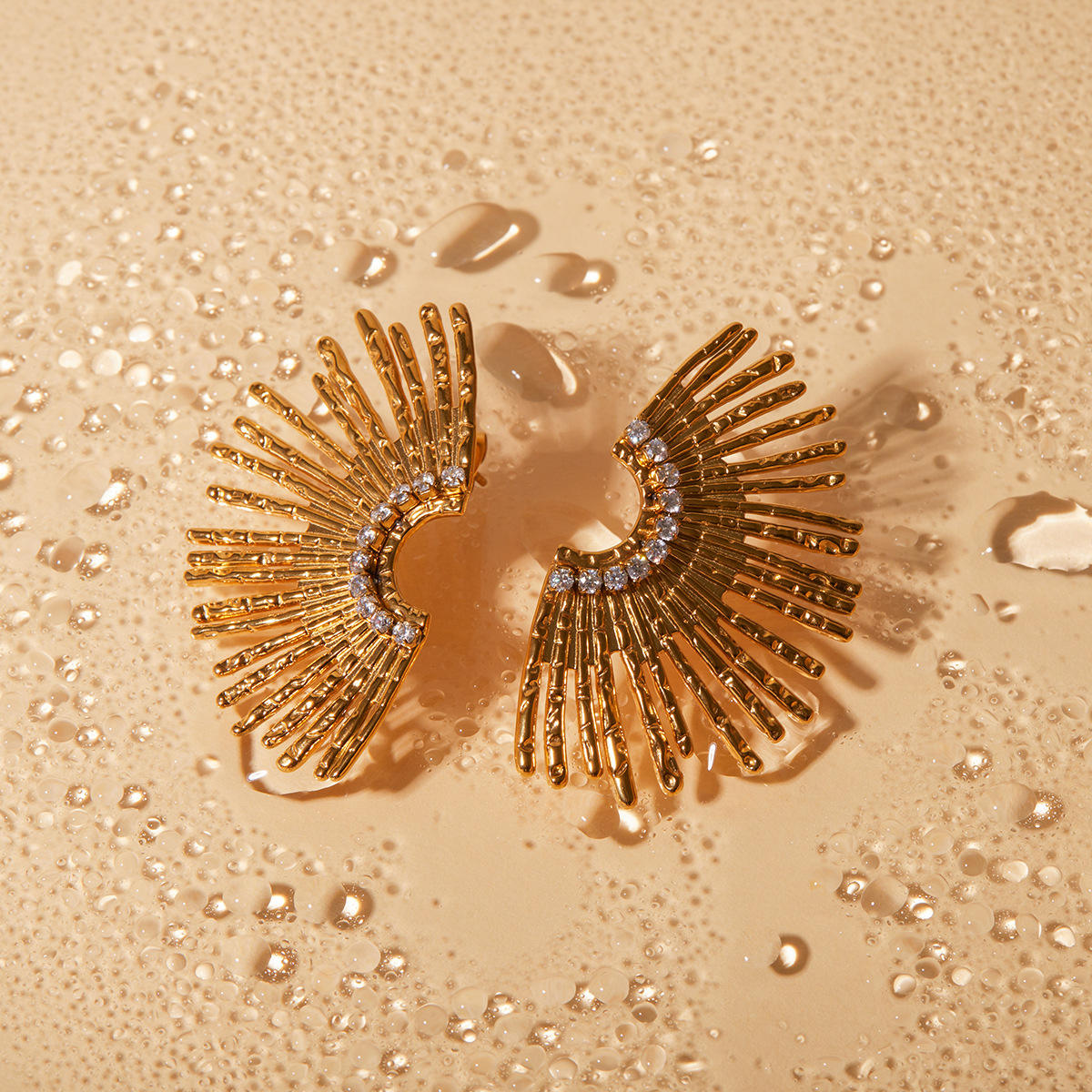Orek Ivra Golden Petal Earring earrings on jewellery display, a scalloped sunflower silhouette lined w