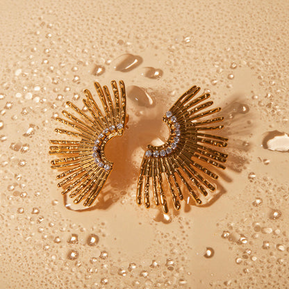 Orek Ivra Golden Petal Earring earrings on jewellery display, a scalloped sunflower silhouette lined w