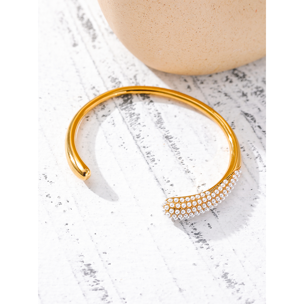 Woman wearing Orek Perla Pearl Inlaid Bangle bracelet