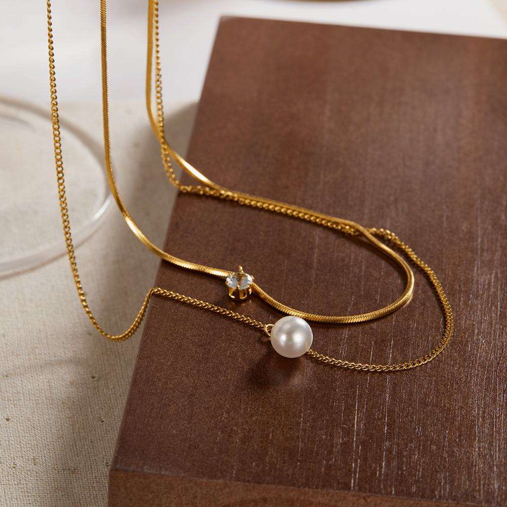 Orek Evara Twin Grace Necklace necklace on jewellery display, a dual-layer chain finished with a pearl