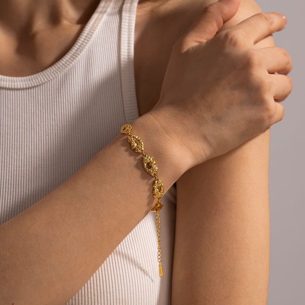 Orek Vesta Volcano Pattern Bracelet bracelet on jewellery display, an irregular, molten-texture surface ins