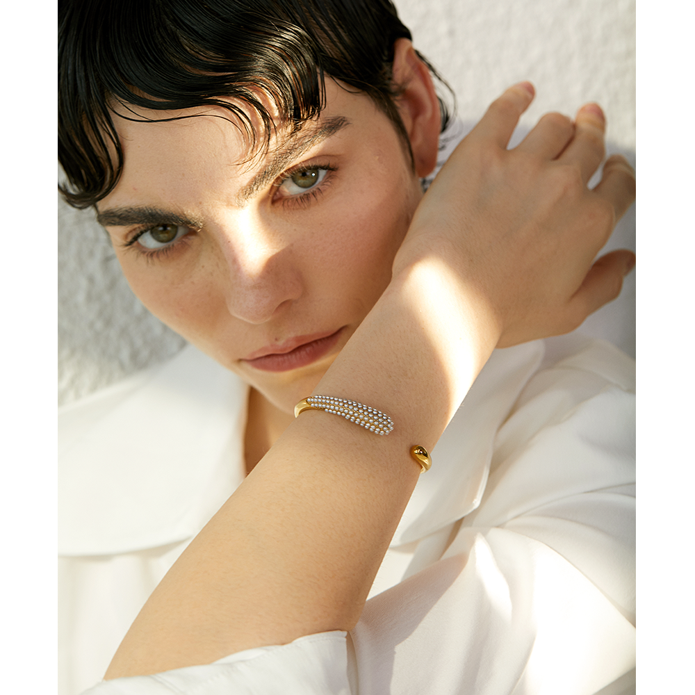 Close-up of Orek Perla Pearl Inlaid Bangle bracelet detail, a row of inlaid pearls set flush into a 