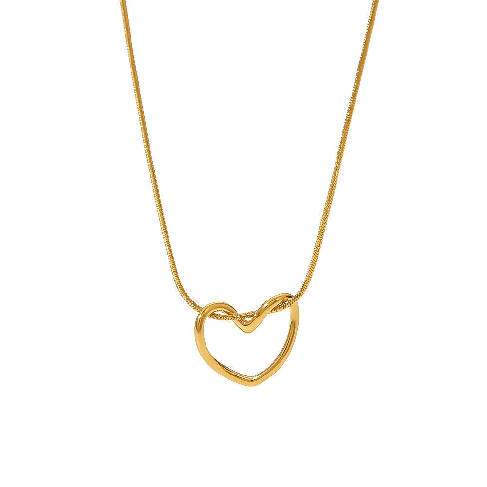 Orek Arelia Pure Heart Necklace necklace on jewellery display, a hollow-out heart pendant on a delicate