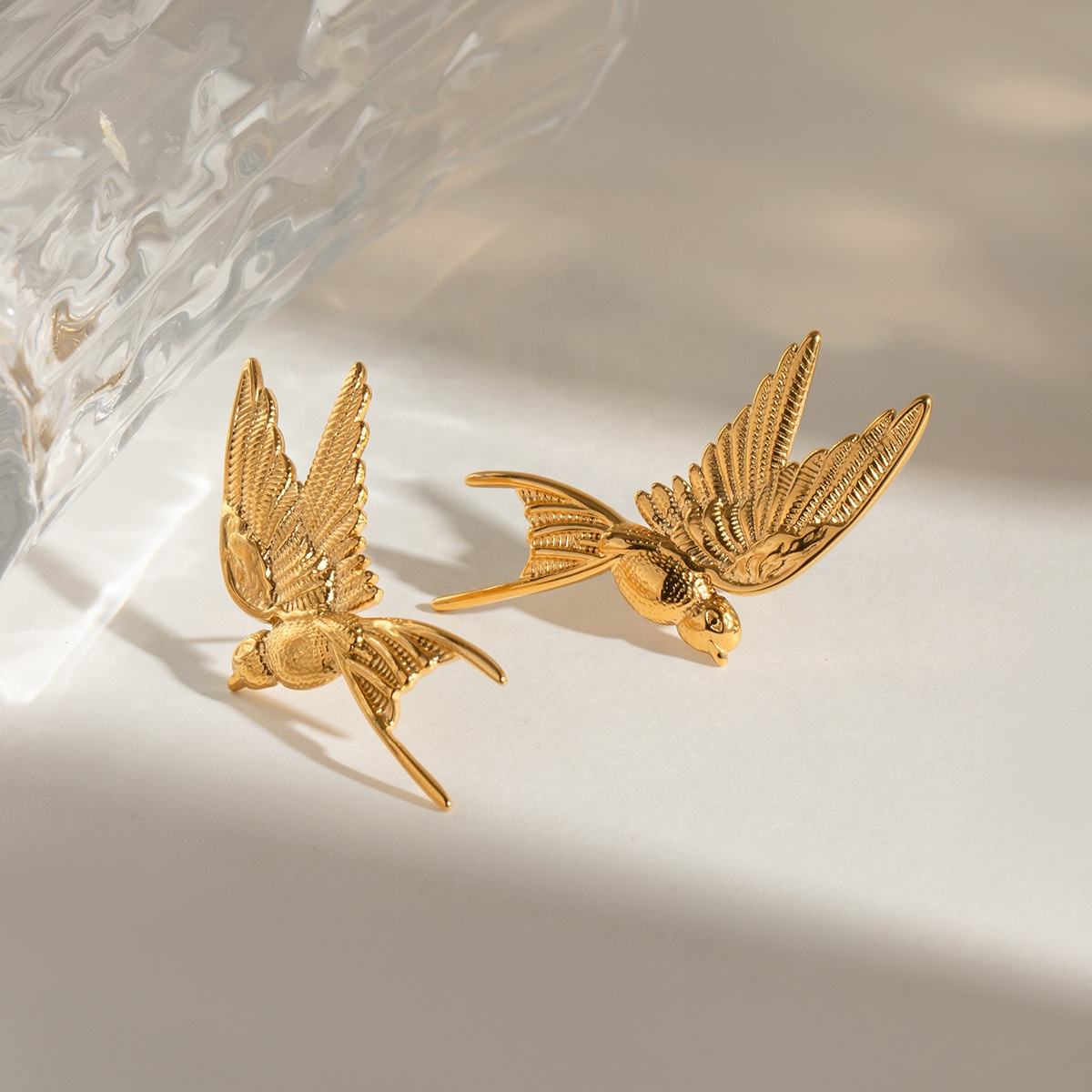Orek Elara Peace Kingfisher Wing Earring earrings on jewellery display, a sculpted wing silhouette inspired by p