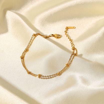 Close-up of Orek Ira Double Chain Bracelet bracelet detail, two fine chains layered with a row of sm