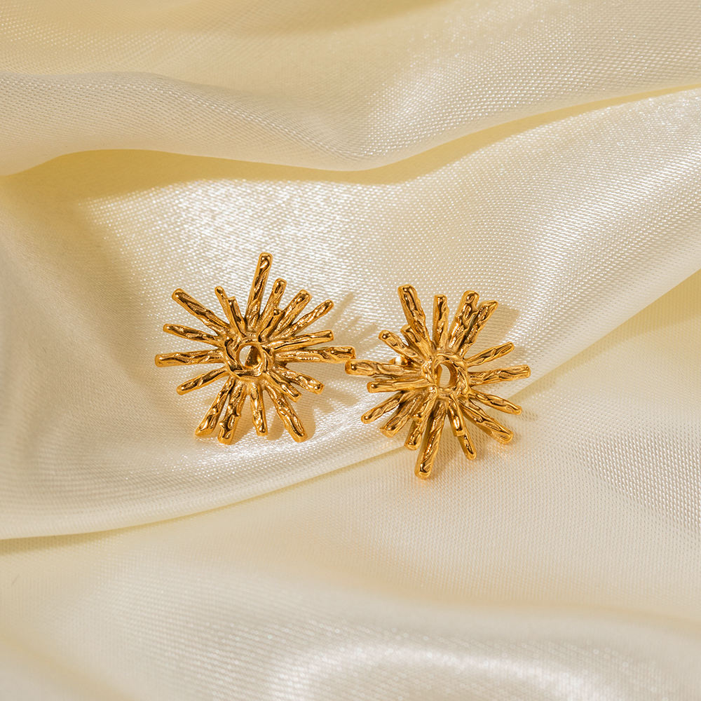 Orek Evara Burning Sun Studs earrings on jewellery display, a textured, lava-finish sunburst with ra