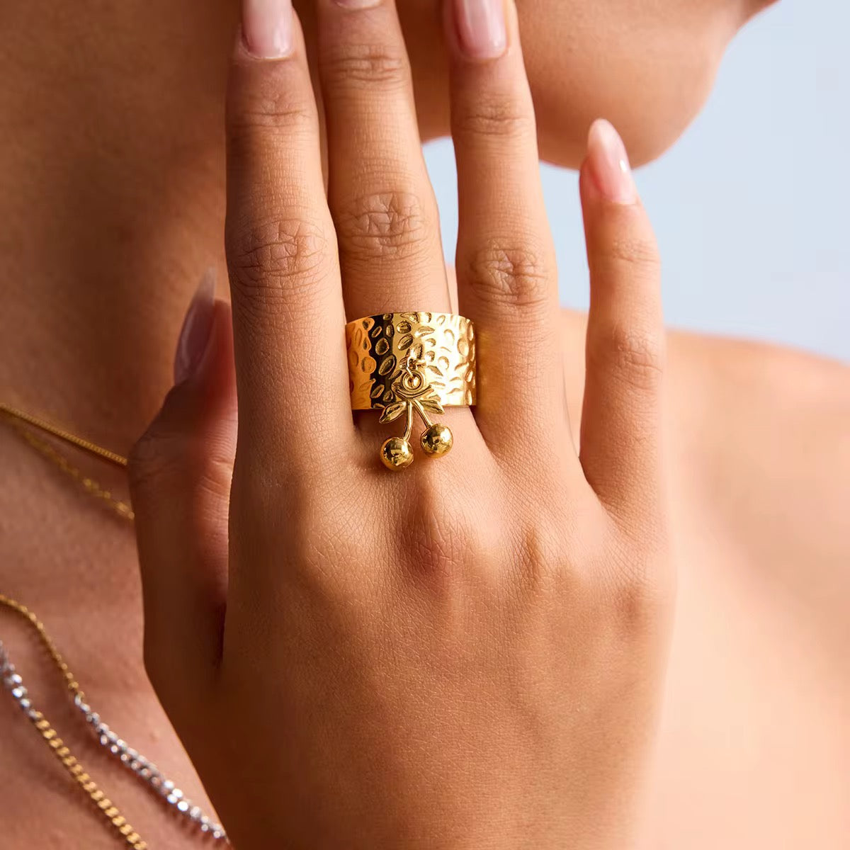 Close-up of Orek Hammered Cherry Ring, showing anti-tarnish gold plated finish