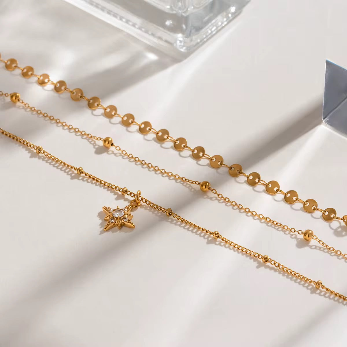 Close-up of Orek Aira Star Layers Necklace showing layered chain design