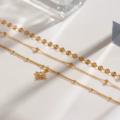 Close-up of Orek Aira Star Layers Necklace showing layered chain design