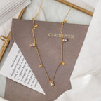 Close-up of Orek Arelia Square Poise Necklace geometric square pendant