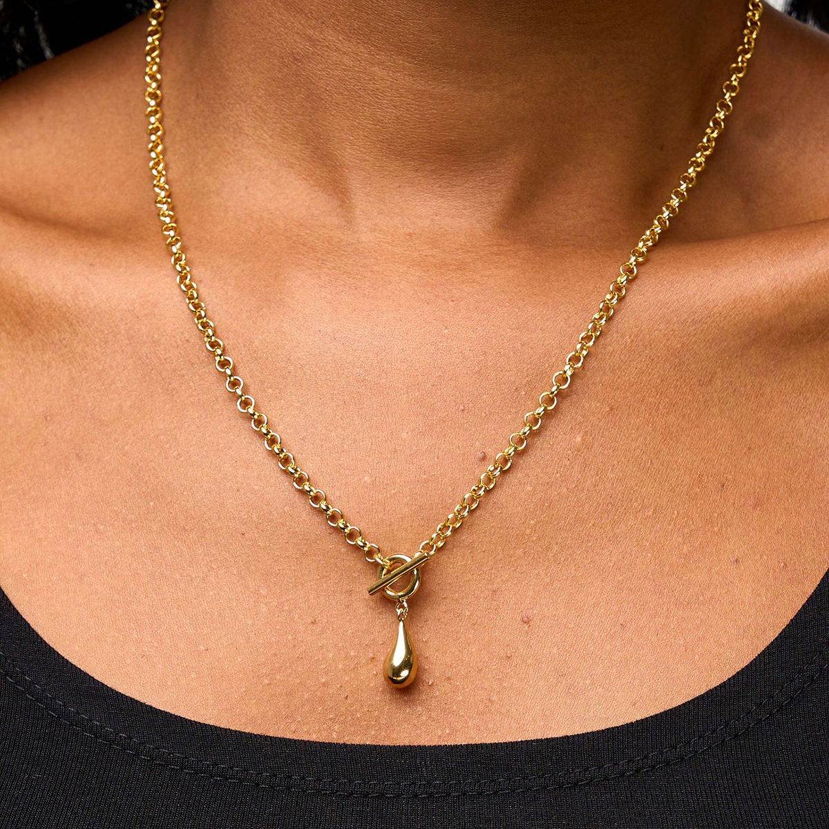 Model wearing the Orek Ciela Drop Knot Necklace styled with casual fashion, showcasing a minimal waterproof gold pendant necklace for women.