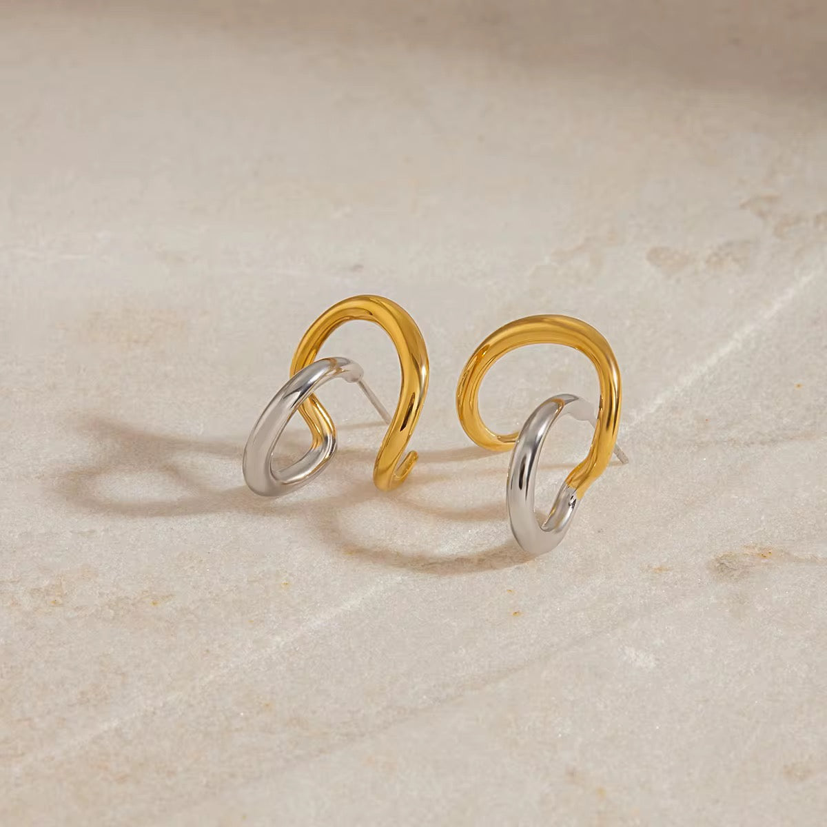 Close-up of Orek Elia Dual Line Studs showing dual-line geometric design