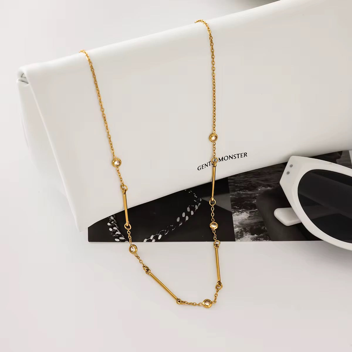 Close-up of Orek Ira Linear Charm Necklace, showing anti-tarnish gold plated finish
