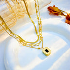 Close-up of Orek Noira Heart Layers Necklace with green heart pendant