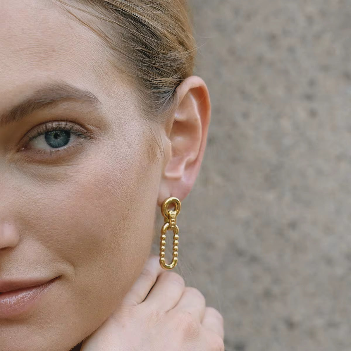 Close-up of Orek Nyra Oval Muse Earring, showing anti-tarnish gold plated finish