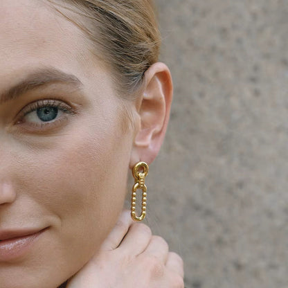 Close-up of Orek Nyra Oval Muse Earring, showing anti-tarnish gold plated finish