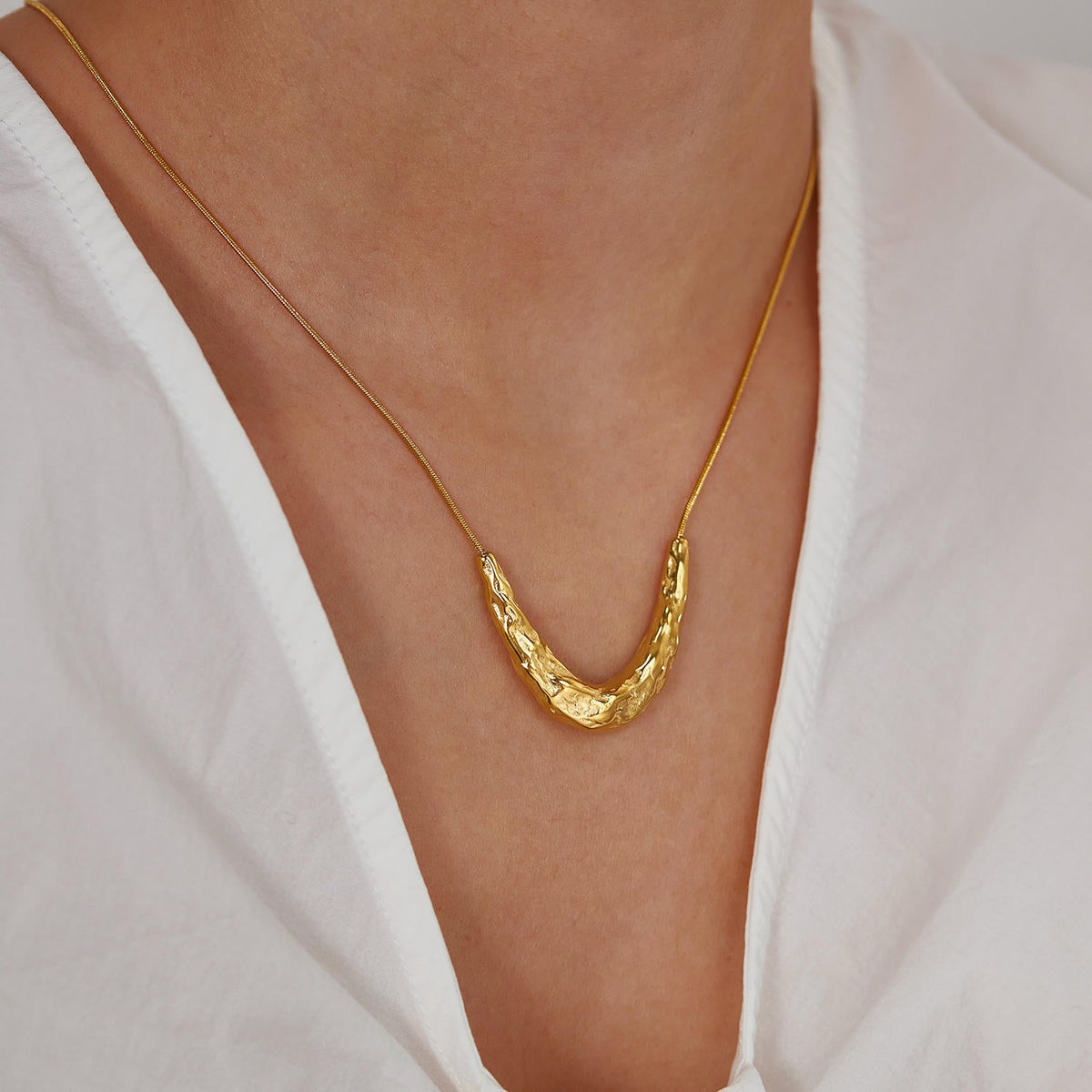 Close-up of Orek Oria Hammered Calm Necklace, showing anti-tarnish gold plated finish