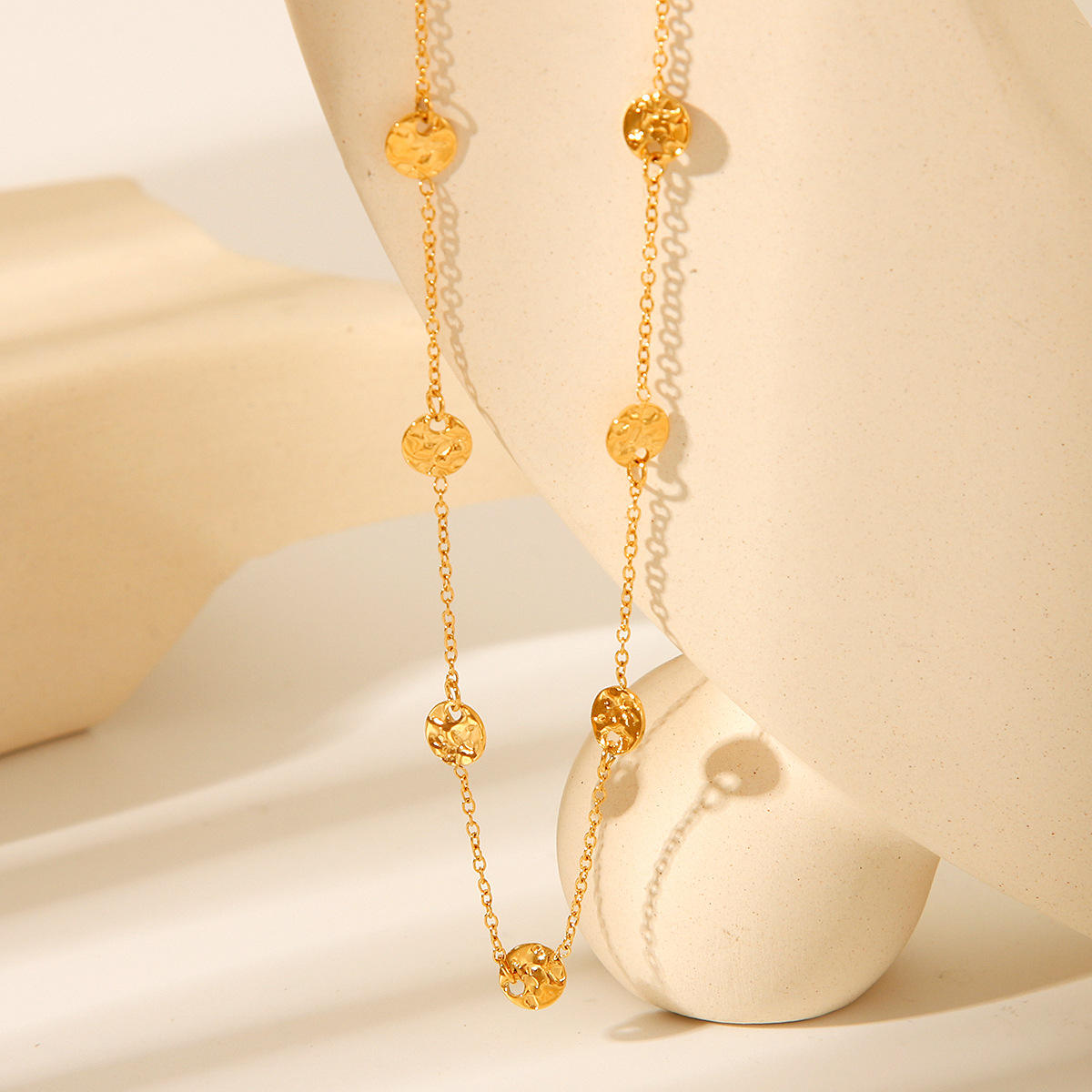 Flat lay of the Orek Oria Hammered Dots Necklace highlighting its minimalist waterproof gold chain design.