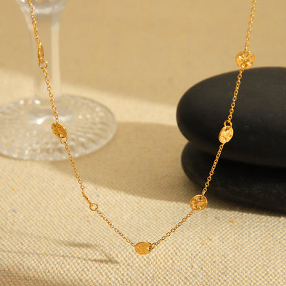 Side angle of the Orek Oria Hammered Dots Necklace showcasing its delicate gold chain and hammered dot accents.