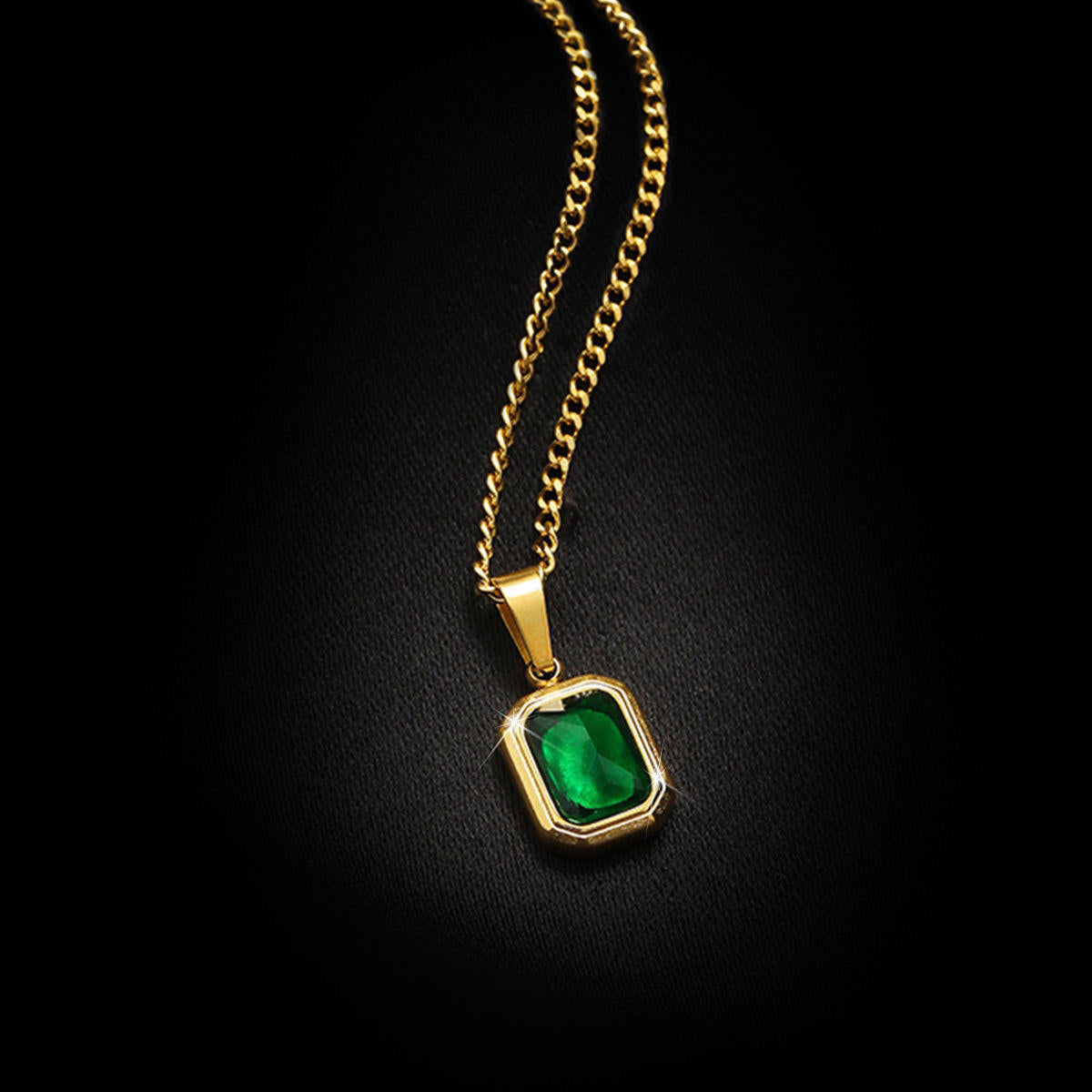 Close-up of Orek Veya Emerald Poise Necklace featuring an emerald green pendant