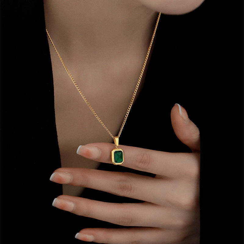 Woman wearing Orek Veya Emerald Poise Necklace with elegant everyday styling