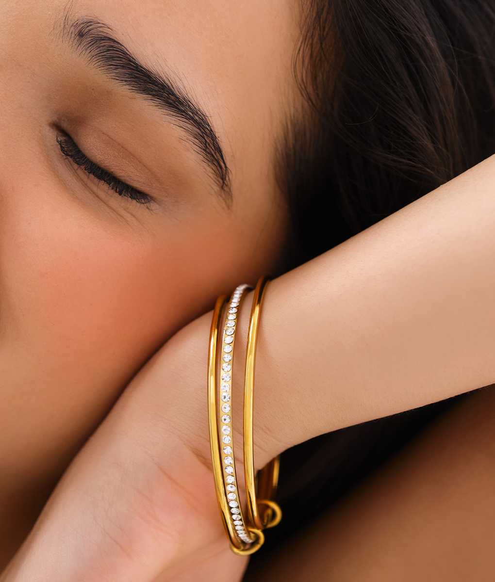 Close-up of Orek Veya Trio Poise Bangle showing polished triple-band minimalist design