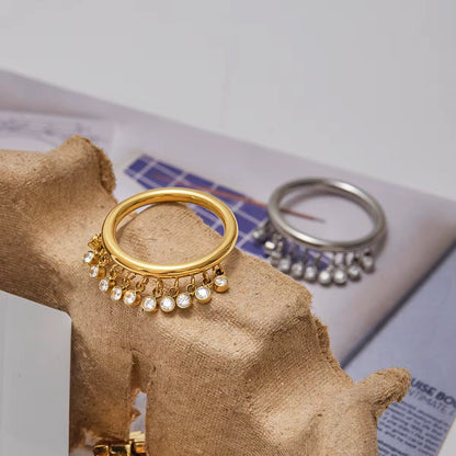 Close-up of Orek Zircon Tassel Charm Ring with zircon detailing